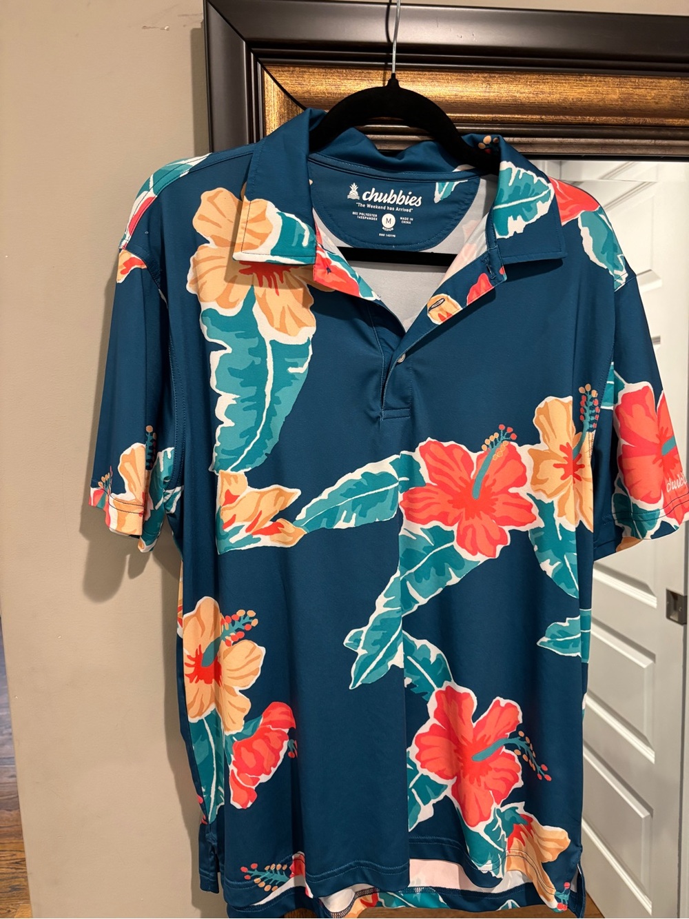 chubbies Teal Tropical Floral Polo with Coral & Peach Blooms